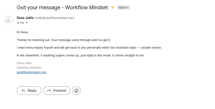 The automated reply received in a Gmail inbox, sent from the business domain